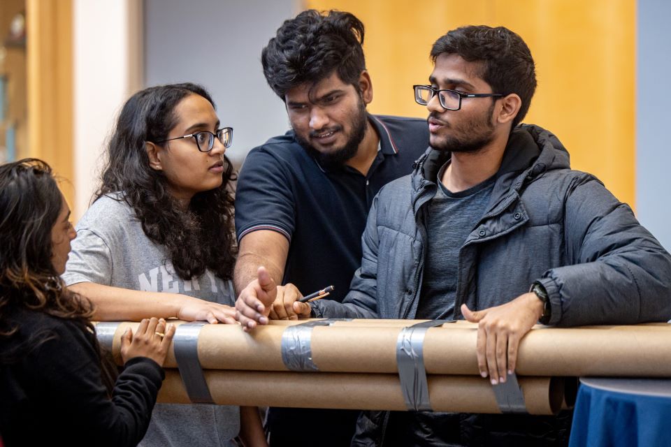 School of Science and Engineering students construct a bridge out of cardboard and duct tape during the SSE Innovation Challenge with industry partner TWM on November 13, 2024. 