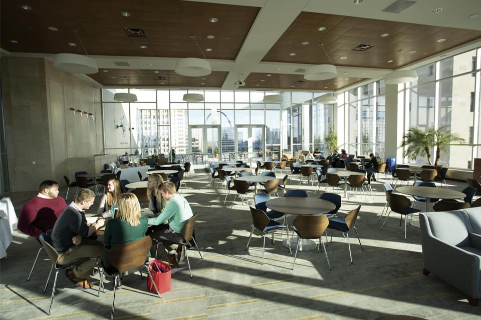 A meeting area at SLU Law with the STL arch visible through windows