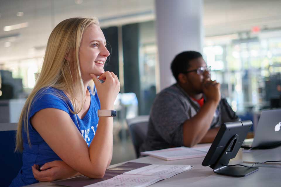 Two students in classroom looking forward