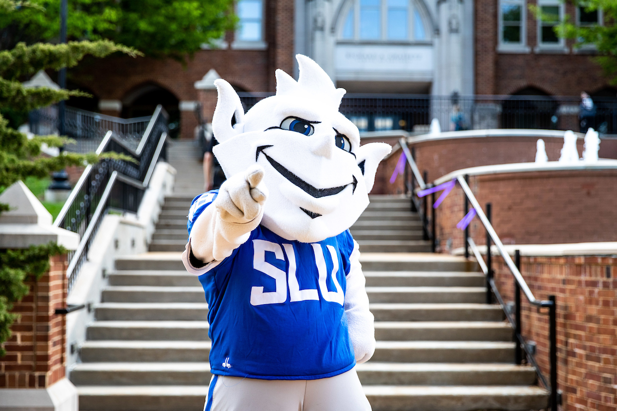 Saint Louis University Billiken Mascot pointing toward viewer