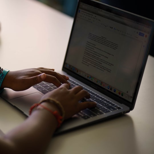 Photo of hands typing on a laptop