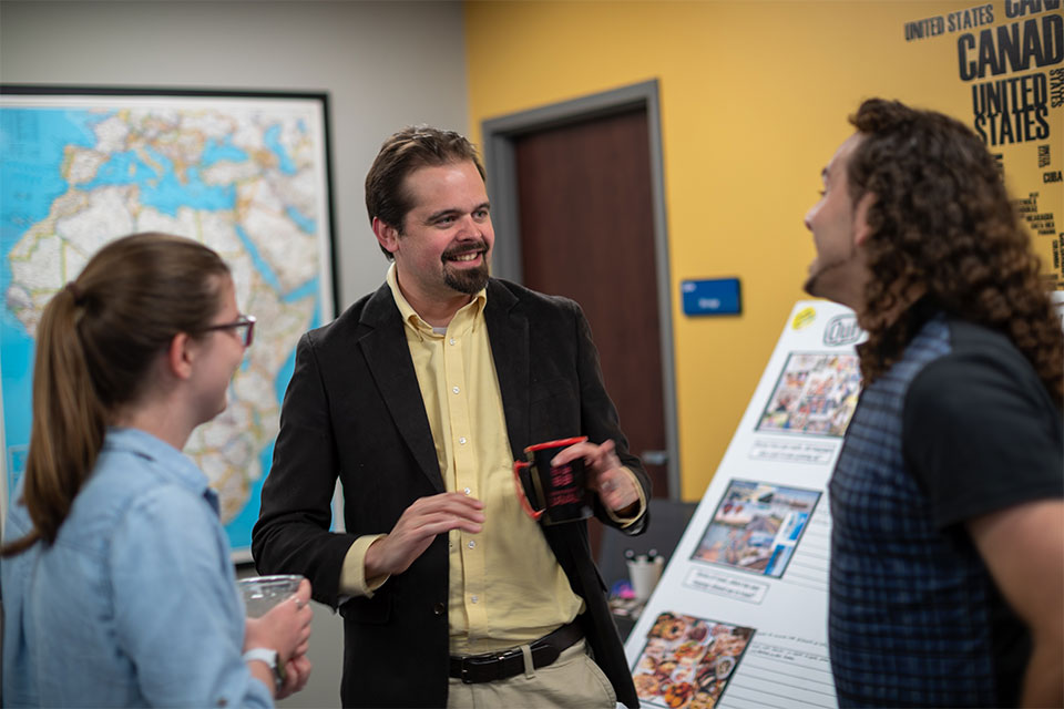 SLU students and professor chat at Polyglot Café