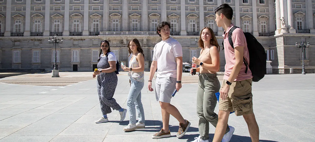 A group of SLU students walk through the grounds of Madrid's Royal Palace.