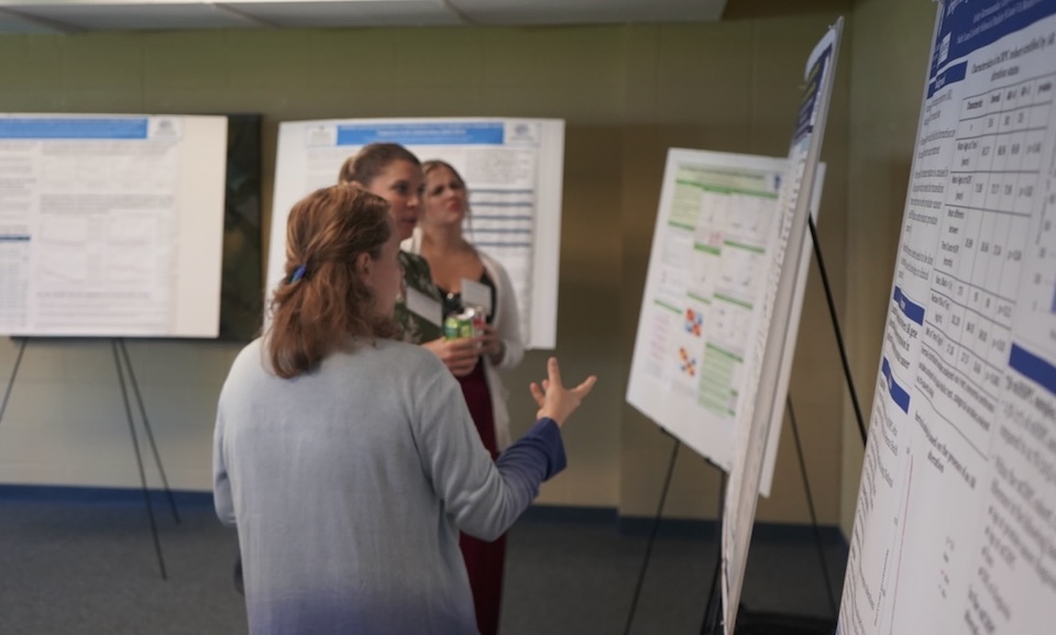 researcher presents poster