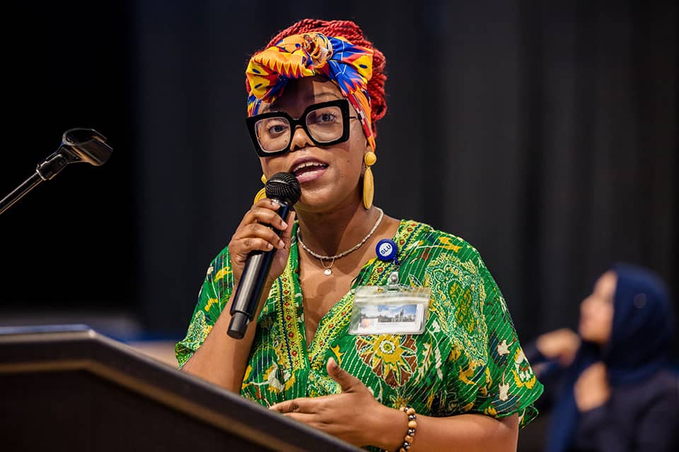 Luella Loseille speaks to students during the Oath of Inclusion event at Chaifetz Arena.