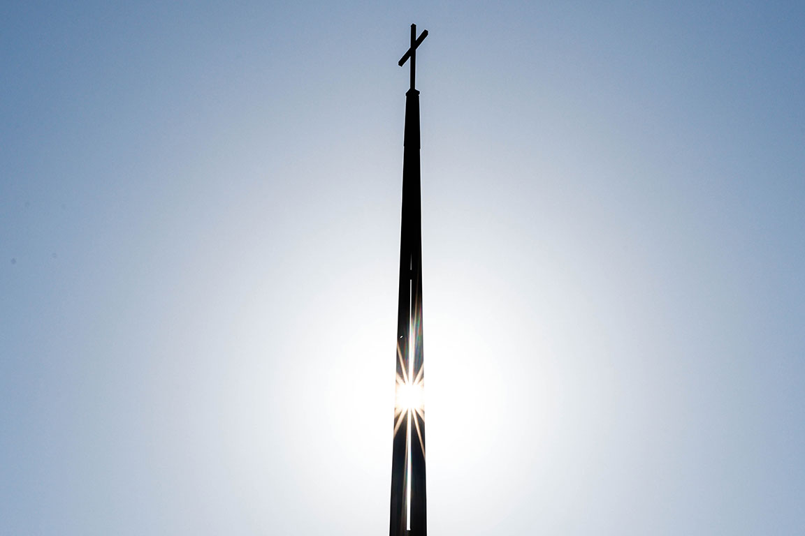 Sunlight shines through the steeple on the chapel of SLU's Jesuit Center